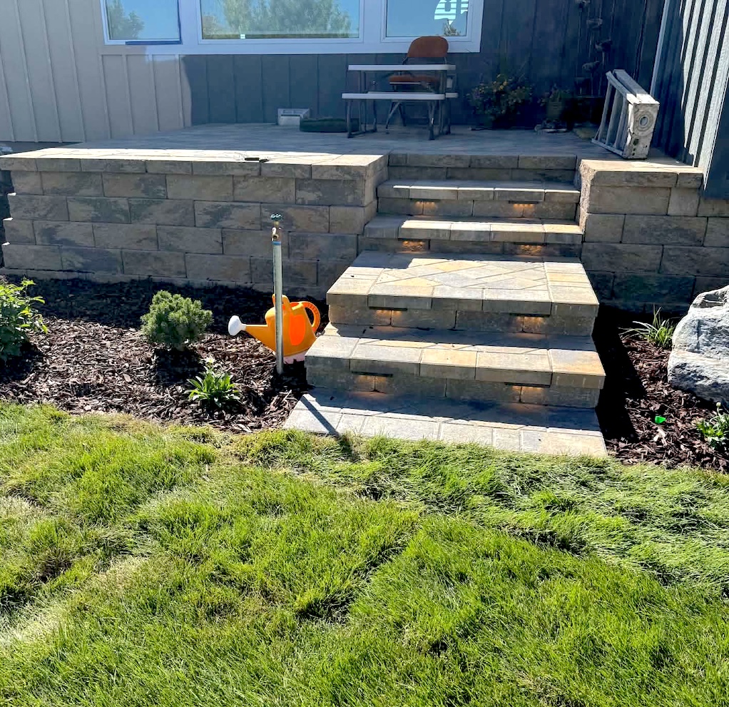 Segmental concrete block retaining wall with integrated steps and landscape lighting in Idaho Falls ID